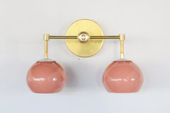 Peach and brass two light wall sconce with white flowers.  Bathroom retro wall sconce with flowers