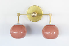 Peach and brass two light wall sconce with white flowers.  Bathroom retro wall sconce with flowers