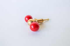 Another close look at the red and brass double-ball knob, showing the glossy finish and proportions from a slightly different angle. Useful for checking scale and color against your own cabinetry. Colorful bathroom or furniture cabinet pull in bright glossy red and brass