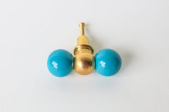 Teal and brass double gumball knob, two glossy teal balls flanking a brass center ball. A colorful hardware pick for furniture makeovers, bathroom vanities, built-in cabinets, kitchens, kids' rooms, or offices, anywhere that needs a little personality.