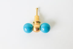 Teal and brass double gumball knob, shown at a slight angle. A versatile colorful knob that suits dresser makeovers, colorful bathrooms, kitchen cabinetry, built-ins, kids' spaces, and offices alike.