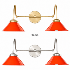 A red orange two-light gooseneck wall sconce with glossy cone shades, shown in Flame with brass or nickel hardware. It has two curved gooseneck arms joined by a straight crossbar at a round backplate, so it sits wide like a vanity light. Hang it over a bathroom mirror, a kitchen counter, or a home coffee bar. Red orange looks great with teal or cobalt walls, terrazzo, and warm walnut, so it suits mid century modern, 70s inspired, and eclectic rooms.