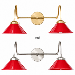 A bright red two-light gooseneck wall sconce with glossy cone shades, shown in Red with brass or nickel hardware. It has two curved gooseneck arms joined by a straight crossbar at a round backplate, so it sits wide like a vanity light. Hang it over a kitchen sink, a bathroom mirror, or over open shelving. Red looks sharp on white subway tile, navy walls, and checkerboard floors, so it suits retro kitchen, diner style, and eclectic farmhouse decor.