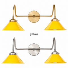 A yellow two-light gooseneck wall sconce with glossy cone shades, shown in Yellow with brass or nickel hardware. It has two curved gooseneck arms joined by a straight crossbar at a round backplate, so it sits wide like a vanity light. Hang it over a bathroom mirror, above a kitchen sink or window, or over open shelving. Sunny yellow looks great with white subway tile, blue and white patterns, and warm wood, so it suits retro kitchens, cottage bathrooms, and cheerful farmhouse rooms.