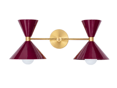 Black Cherry double cone wall sconce with brass arm and round brass backplate, a modern mid century inspired bathroom vanity light with two sculptural powder coated metal shades and exposed globe bulbs, bold colorful wall lighting for maximalist interiors, powder rooms, kids bathrooms, nurseries, and playful contemporary design. Beautiful jewel-tone light fixture.