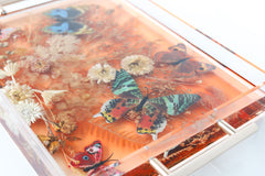 Floral Tray with translucent orange color, neutral florals, and colorful butterflies