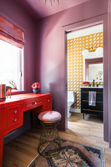 Purple Vestibule with red laquered desk and mustard bathroom behind it.  Gorgeous saturated color used in interior design