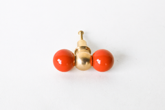A double-ball cabinet knob pairing two glossy flame-colored spheres with a polished brass ball at the center, more punch than a standard single knob. A confident, warm-toned pick for a bold kitchen, a maximalist bar cabinet, or anywhere that wants real color instead of playing it safe.