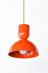Bright orange is the color that instantly wakes up a kitchen, and this Taeuber pendant brings it in a punchy sculptural shape. A rounded cup stacks over a wide domed bell, finished in glossy flame with a warm brass stem. It reads playful and confident, the kind of statement lighting that turns an island, nook, or sink into a focal point. Hang one as a pop of color or a row for real impact. A great choice for a colorful, collected home that treats bold color as a neutral and loves a little fun overhead.