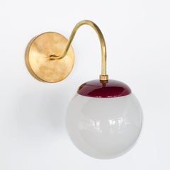 Brass and Black Cherry Marroon Mid Century modern style wall sconce with white globe shade