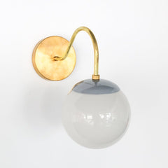 Brass and grey Mid Century modern style wall sconce with white globe shade