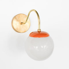 Brass and Orange Mid Century modern style wall sconce with white globe shade