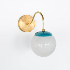 Brass and teal Mid Century modern style wall sconce with white globe shade