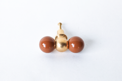A double-ball cabinet knob pairing two glossy fudge brown spheres with a polished brass ball at the center, warmer and moodier than the brand's brighter colorways. A rich, comfort-toned pick for a chocolate kitchen, a moody library built-in, or any cabinetry that wants depth instead of a bright pop.
