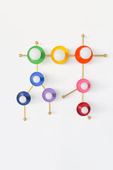 The Rainbow Gemini One in brass is a colorful constellation-inspired wall sconce that turns the Gemini zodiac sign into functional art. Bright rainbow discs in green, yellow, red, pink, purple, and blue are connected by warm brass arms, creating a playful celestial silhouette with major personality. This statement wall light is perfect for maximalist interiors, kids’ rooms, playrooms, nurseries, colorful bathrooms, eclectic homes, and spaces designed by art-loving interior designers who want lighting that f
