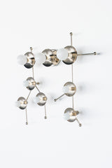Studio product photo of the Gemini One Sconce in all chrome, designed around the shape of the Gemini constellation. White globe bulbs sit on polished chrome discs and linear arms, creating a graphic celestial wall light that works like functional wall art. This piece fits modern homes, playful kids rooms, astrology-inspired bedrooms, maximalist hallways, nurseries, and contemporary powder rooms. Strong keywords include Gemini sconce, chrome wall sconce, constellation lighting, star sign decor, zodiac light 