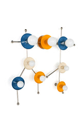 This Gemini One wall sconce uses mustard yellow, denim blue, cream, chrome, and white globe bulbs to create a bright constellation-inspired fixture with a playful vintage-modern mood. The shape follows the Gemini star pattern, making it feel like both lighting and wall sculpture. It is a strong fit for maximalist decor, eclectic interiors, kids spaces, astrology-themed rooms, colorful bathroom lighting, and customers looking for an unusual zodiac wall light that feels fun without looking childish.