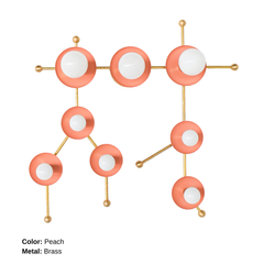 Peach and brass Gemini One wall sconce shown in a studio setting against a light neutral background. This sculptural celestial wall light is designed to resemble the Gemini star constellation, with pastel peach metal discs, warm brass arms, and white globe bulbs arranged in an abstract constellation pattern. The look is playful, artistic, and distinctly modern, making it a standout choice for maximalist interiors, eclectic homes, colorful nurseries, creative playrooms, astrology-inspired decor, and zodiac-t
