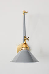 Grey and Brass adjustable cone sconce for kitchen lighting above windows or above open shelving cabinetry.  Also makes a great bedside reading light that frees up space on your nightstands. Comes in three finishes and over 30 colors for a custom look.  Available in neutrals or fun, bright colors that work in any maximalist or kid-friendly space.  Classic style wall sconce that has been updated by our curated color palette of brights, darks, and pastel hues.  Designed and made by Sazerac Stitches.