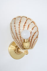 Art Deco-inspired hand-painted wall sconce with a fluted shell-shaped shade in warm cream and layered brown brushwork, finished with fully brass hardware; limited edition lighting from Sazerac Stitches’ One-of-One collection