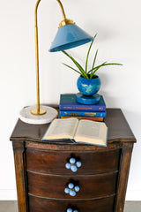 Cube ball drawer pull on an antique wood nightstand