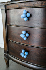 Cube ball drawer pull on an antique wood nightstand