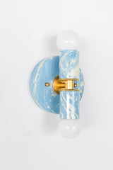 Hand-marbled Small Thalia Sconce featuring airy Hydrangea blue, creamy white marbling, and warm gold details. Each fixture has a unique small-batch finish, making it a charming wall light for colorful bathroom designs, double vanity sconces, powder rooms, coastal cottage decor, and grandmillennial wallpapered spaces.