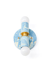 A small hand-marbled Thalia wall sconce in Hydrangea blue, Cream, and Gold, with a one-of-a-kind painted finish that feels soft, watery, and custom. The compact two-light shape makes it easy to use above mirrors, beside vanities, in powder rooms, or anywhere a small bathroom needs colorful handmade lighting.