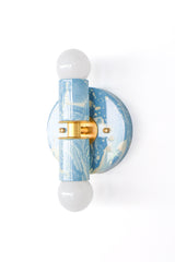 Hydrangea, Cream, and Gold hand-marbled Small Thalia Sconce with soft blue and cream swirls, brass hardware, and white globe bulbs. This compact two-light wall sconce is a colorful choice for bathroom vanity lighting, powder rooms, kids bathrooms, coastal interiors, cottage style spaces, and blue and white grandmillennial decor.