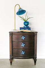 Cube ball drawer pull on an antique wood nightstand