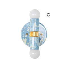 Hydrangea and Cream hand-marbled Small Thalia Sconce with gold accents and white globe bulbs, shown in a clean product photo that highlights the soft swirling finish. Each fixture has its own hand-applied marbled pattern, making every sconce slightly different. This small colorful wall light works beautifully in muted blue bathrooms, coastal powder rooms, children’s bathrooms, playful guest baths, cottage interiors, and wallpapered spaces with soft blue, cream, white, and brass details.