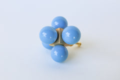 Hydrangea blue and brass oversized ball cube drawer pull shown on a white background; designed with five lacquered blue spheres arranged in a cube formation on a polished brass base, perfect for high-end interior hardware styling.