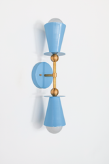Both cone shades of this hydrangea blue vanity sconce face the camera here, showing the exposed bulb on each side of the backplate. Installed, this fixture mounts vertically and typically comes in pairs flanking a bathroom mirror, so this view is a good preview of how balanced the two sides look next to each other. Works equally well in a nursery, coastal bedroom, or hallway.
