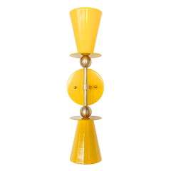 Yellow & Brass Janus Sconce, a bold architectural two light wall sconce with stacked tapered cone shades, flat disc details, and warm brass hardware, shown mounted vertically with globe bulbs, a modern sculptural brutalist meets mid century modern wall light for bathroom vanity lighting, hallway sconces, bedroom bedside lighting, and statement lighting in design forward interiors