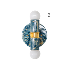 Thalia two-light wall sconce or ceiling flush mount in lagoon, cream, and gold marbled finish, shown on a white background with white globe bulbs and brass center detail. The glossy marbled pattern looks like swirling ocean tones with warm metallic accents. Compact, high-impact statement lighting for small spaces, including powder rooms, corridors, bedrooms, and eclectic or mid-century-inspired interiors.