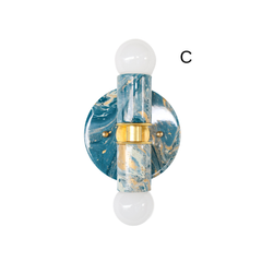 Thalia two-light sconce in lagoon blue, cream, and gold marbled finish, shown straight-on on a white background with white globe bulbs and a brass center band. Handmade glossy marbling varies piece to piece, giving a unique painterly look. Sculptural modern wall sconce or flush mount ceiling light for bold accent lighting in powder rooms, hallways, entryways, bedside walls, and colorful contemporary interiors.