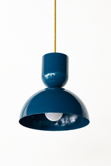A deep, saturated blue-green is the color that makes a kitchen feel classic and a little moody, and this Taeuber pendant carries it in a clean sculptural shape. A rounded cup tops a wide domed bell, finished in glossy blue with a warm brass stem. It reads timeless and confident, the kind of light that turns an island, nook, or sink into a focal point without going loud. Hang one for a hit of color or a row for rhythm. 