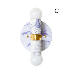 This white and lavender marbled Thalia sconce is a small statement light that feels sweet, decorative, and unique. The soft pastel palette works beautifully in a girls bathroom, nursery, kids bedroom, or colorful powder room, while the marbled surface keeps it feeling custom and collected. With brass hardware and a handmade finish, it also fits well in chinoiserie-style interiors, grandmillennial spaces, and layered homes that mix delicate color with bold pattern and personality.