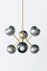Steel and brass industrial inspired metal chandelier with globe shades.  Made in New Orleans. Unique lighting design