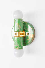 This hand-marbled Thalia sconce pairs spring green, soft cream, and warm gold for a fresh, lively look that instantly brightens a room. Its compact size makes it ideal for bathrooms, small nooks, and other tight spaces where you want a bold detail without overwhelming the room. Because each one is individually marbled by hand, every fixture has its own one-of-a-kind pattern and character. Perfect for eclectic decor, colorful homes, fun powder rooms, and interiors that lean into playful, artful design.