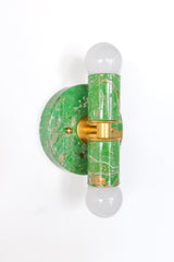 The marbled Thalia sconce in spring green, cream, and gold is a playful statement light that brings color, pattern, and personality to small spaces. Each fixture is hand-marbled, so no two are exactly alike, making every sconce feel like a little functional piece of art. This colorful wall light is especially good for bathroom vanities, powder rooms, hallways, and other compact spaces that need a cheerful pop. A great fit for dopamine decor, eclectic interiors, maximalist homes, and anyone looking for uniqu