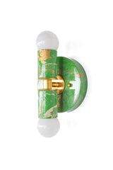 The spring green, cream, and gold Thalia sconce is a colorful, hand-marbled wall light designed to make even the smallest space feel more special. Its cheerful palette and glossy finish bring energy to bathroom walls, powder rooms, kids’ baths, and hallways, while the marbled pattern gives each piece a one-of-a-kind look. This sconce is a great choice for anyone searching for unique bathroom sconces, eclectic wall lighting, colorful vanity lights, or statement lighting for a maximalist interior.