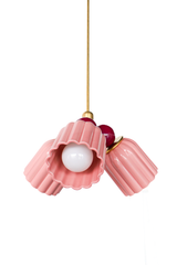 A small chandelier with glossy, glazed fluted ceramic cone shades in pastel pink, paired with rich black cherry powder-coated steel balls and brass hardware. The deep burgundy balls give this pink colorway real depth, keeping it feminine without reading overly sweet. A strong pick for a romantic bedroom, a grandmillennial nursery, or any space that wants a soft pink with a bit of grown-up weight behind it.