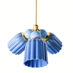 A modern three-light pendant chandelier with fluted blue ceramic shades, light blue spherical accents, and a gold-finished raw brass frame and suspension rod, shown against a solid white background.