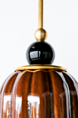 Chicory brown ceramic pendant light with ribbed shaped, celadon style glaze. Modern hand-made pendant light inspired by art deco design.  With a black ball and brass hardware.  Beautiful ceramic pendant light for bathrooms, small rooms, kitchens, and more. 