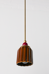 Chicory brown ceramic pendant light with ribbed shaped, celadon style glaze. Modern hand-made pendant light inspired by art deco design.  With a black cherry ball and brass hardware.  Beautiful ceramic pendant light for bathrooms, small rooms, kitchens, and more. 