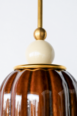 Chicory brown ceramic pendant light with ribbed shaped, celadon style glaze. Modern hand-made pendant light inspired by art deco design.  With a cream ball and brass hardware.  Beautiful ceramic pendant light for bathrooms, small rooms, kitchens, and more. 