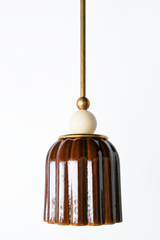Chicory brown ceramic pendant light with ribbed shaped, celadon style glaze. Modern hand-made pendant light inspired by art deco design.  With a cream ball and brass hardware.  Beautiful ceramic pendant light for bathrooms, small rooms, kitchens, and more. 