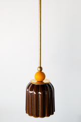 Chicory brown ceramic pendant light with ribbed shaped, celadon style glaze. Modern hand-made pendant light inspired by art deco design.  With a matte mustard ball and brass hardware.  Beautiful ceramic pendant light for bathrooms, small rooms, kitchens, and more. 