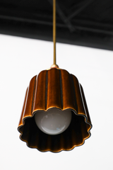 Chicory brown ceramic pendant light with ribbed shaped, celadon style glaze. Modern hand-made pendant light inspired by art deco design.  With a black cherry ball and brass hardware.  Beautiful ceramic pendant light for bathrooms, small rooms, kitchens, and more. 
